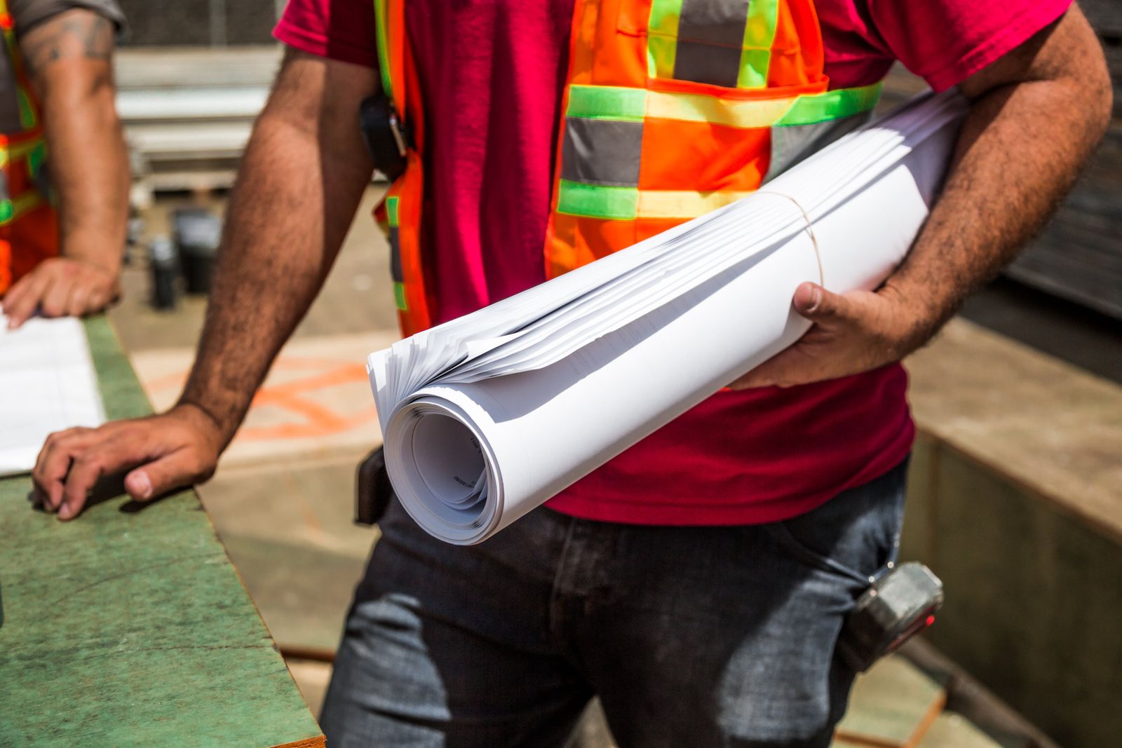 Site workers reviewing project drawings