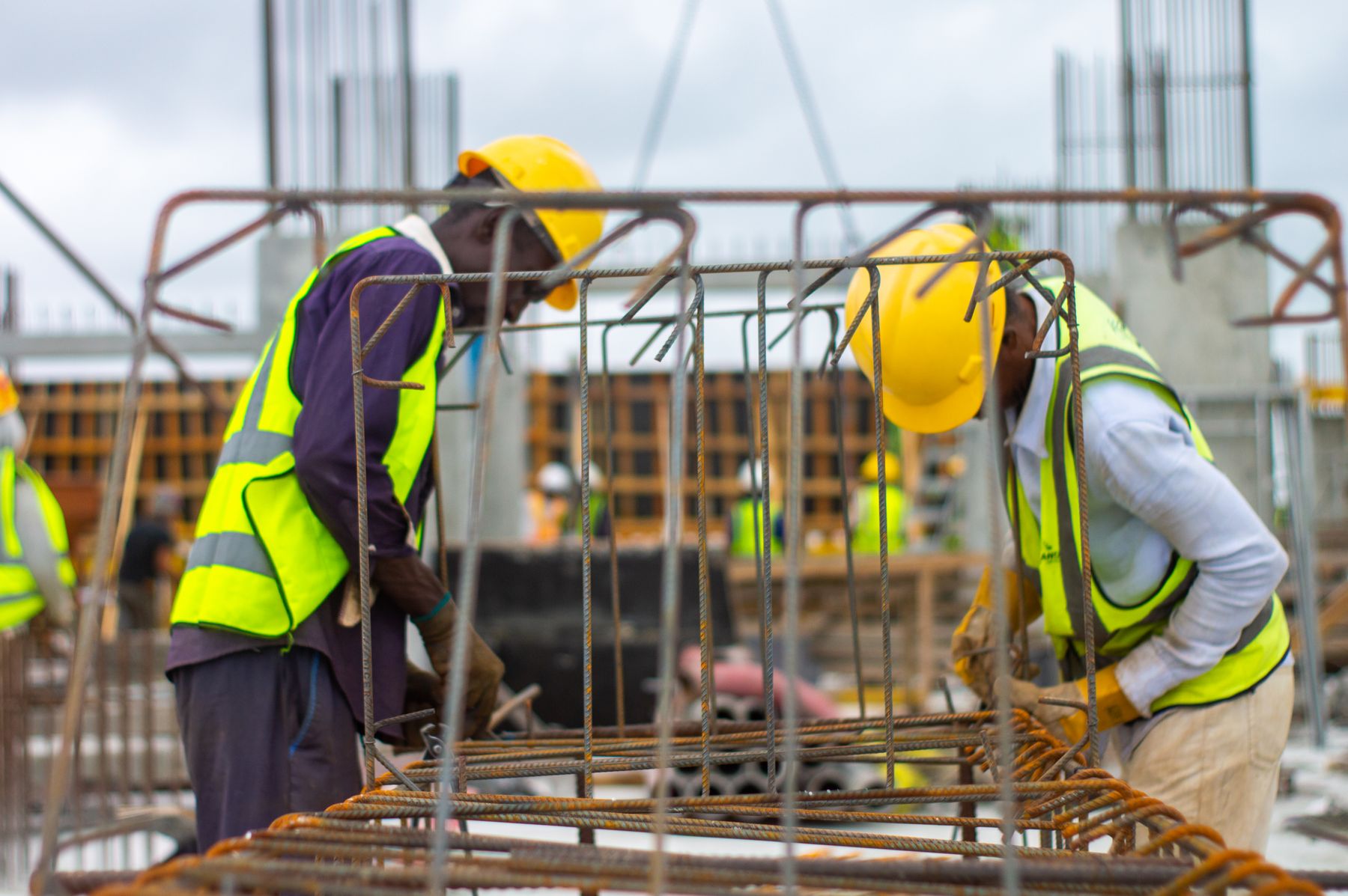 Construction workers installing reinforcement on an active site
